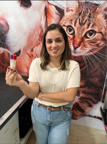 Profissional da Vet Mais Três Fronteiras com tubos de coleta para exames de sangue de cães e gatos